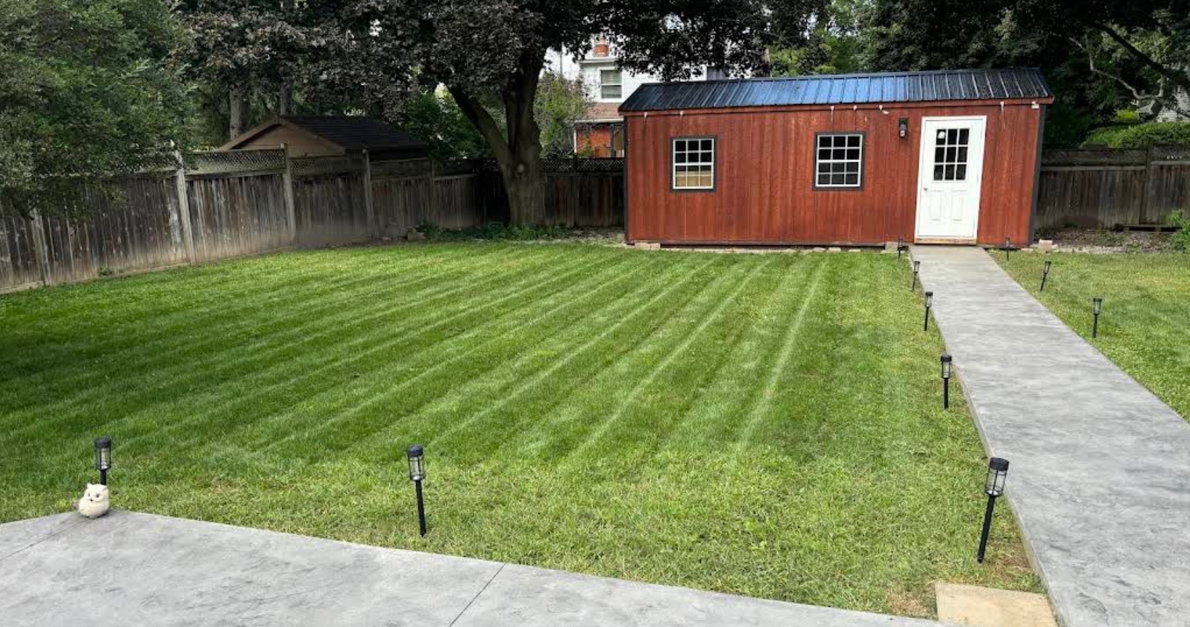 Residential lawn care service showing professionally maintained striped lawn in Brantford